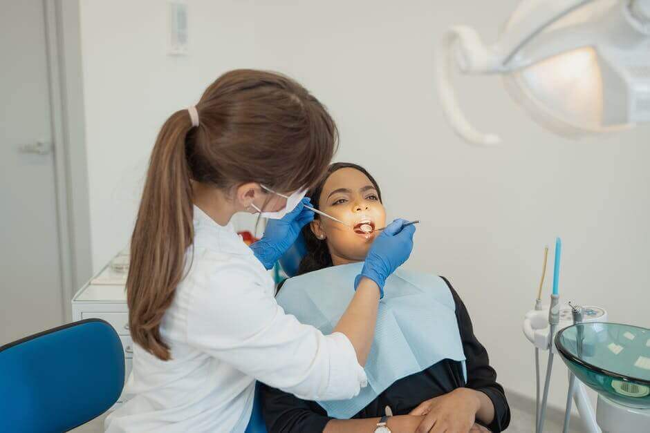 doctor looking at a patients teeth